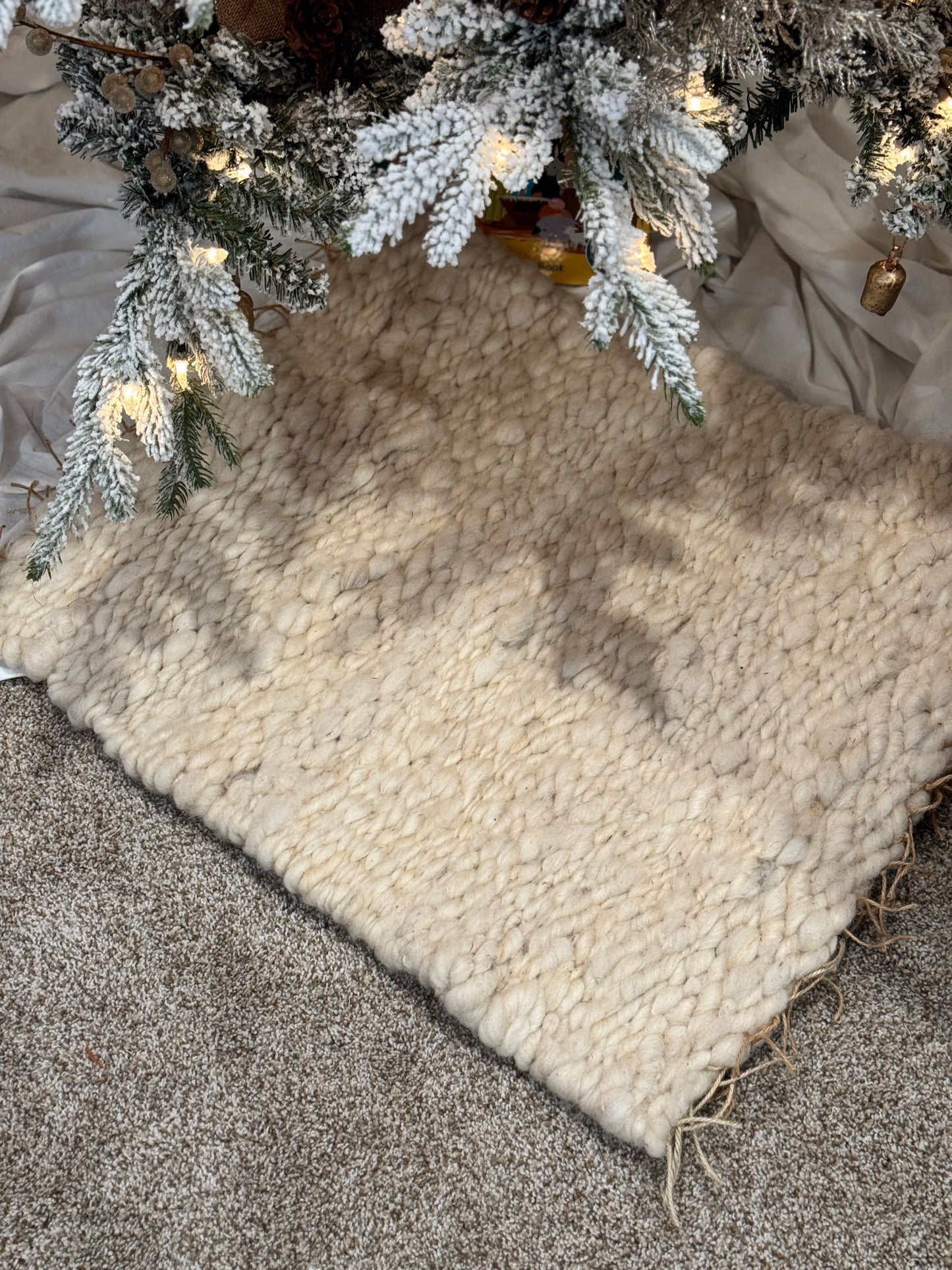 This beautiful hand woven, off white, sheep wool rug is made from 100% sheep wool grown right here at Wild Daisy Homestead.
The warp and trim are made with 100% natural jute string. Created on a peg loom this 23X26 rug is tightly woven together. When removed, the finishing touches by tying the trim and hand stitching of the 100% leather tag attached, complete the project.