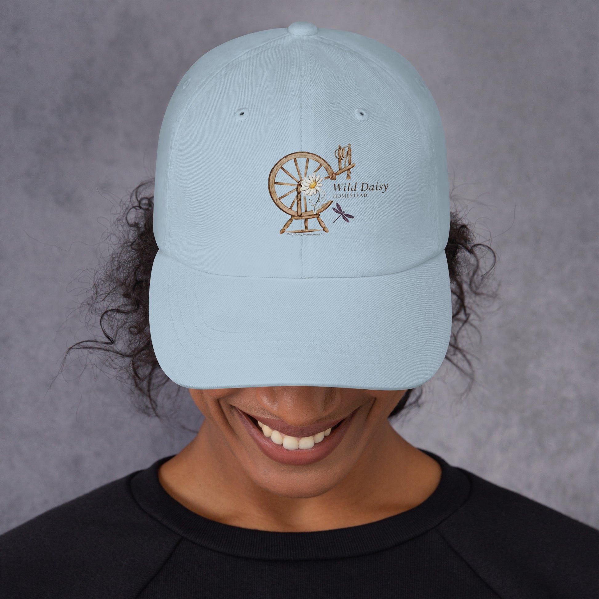 Whimsical Spinning Wheel and Dragonfly Graphic Dad Hat in Light Blue.
