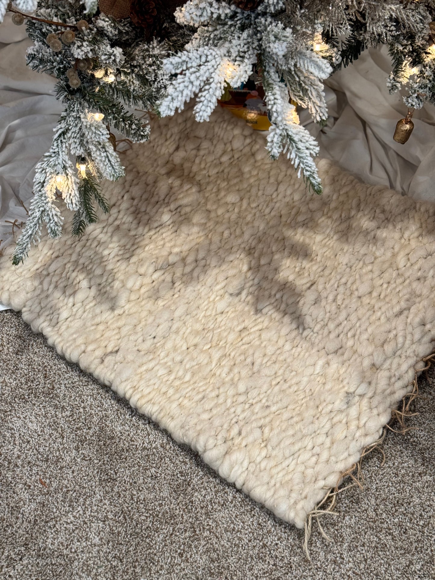 This beautiful hand woven, off white, sheep wool rug is made from 100% sheep wool grown right here at Wild Daisy Homestead.   
The warp and trim are made with 100% natural jute string.  Created on a peg loom this 23X26 rug is tightly woven together. When removed,  the finishing touches by tying the trim and hand stitching of the 100% leather tag attached, complete the project.  