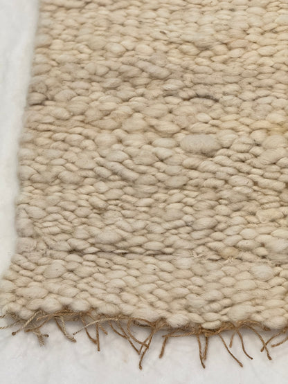 This beautiful hand woven, off white, sheep wool rug is made from 100% sheep wool grown right here at Wild Daisy Homestead.   
The warp and trim are made with 100% natural jute string.  Created on a peg loom this 23X26 rug is tightly woven together. When removed,  the finishing touches by tying the trim and hand stitching of the 100% leather tag attached, complete the project.  